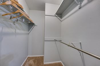 White wall with a brown carpeted stairway